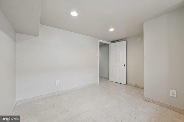 unfurnished room with baseboards and recessed lighting