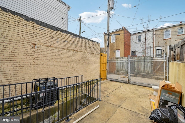 view of patio / terrace featuring fence and central AC