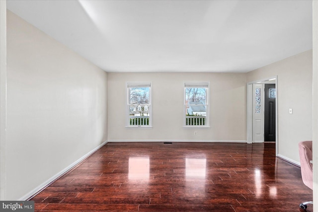 unfurnished room with dark hardwood / wood-style floors