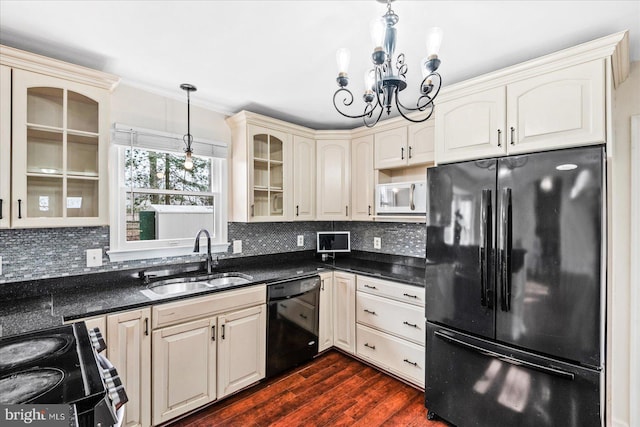 kitchen with sink, backsplash, dark hardwood / wood-style floors, black appliances, and hanging light fixtures