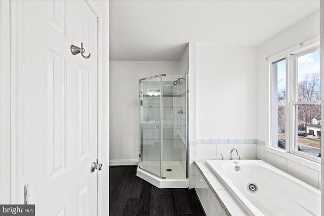 bathroom with separate shower and tub and wood-type flooring