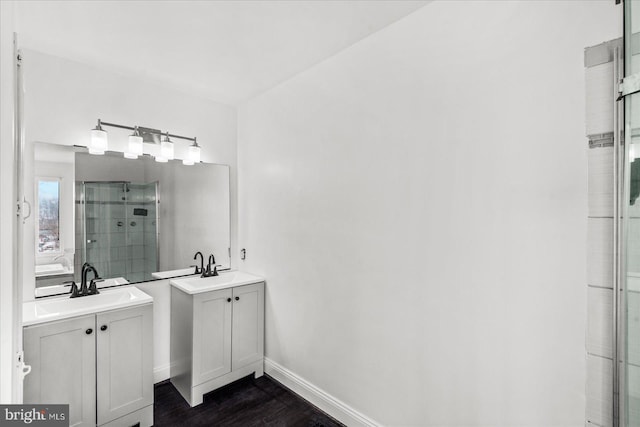 bathroom featuring vanity, walk in shower, and hardwood / wood-style floors