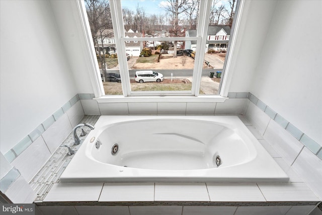 bathroom featuring tiled bath