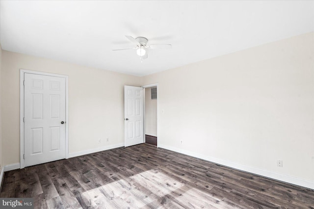 unfurnished bedroom with ceiling fan and dark hardwood / wood-style flooring