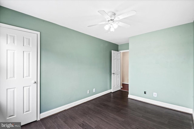 unfurnished bedroom with ceiling fan and dark hardwood / wood-style flooring