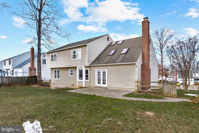 back of property with a patio and a lawn