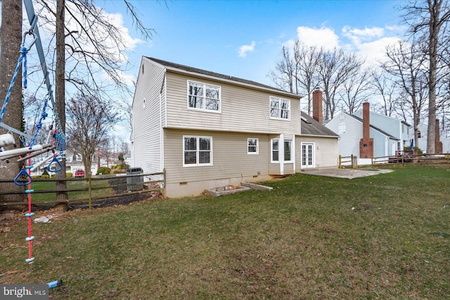 back of property featuring a patio and a lawn