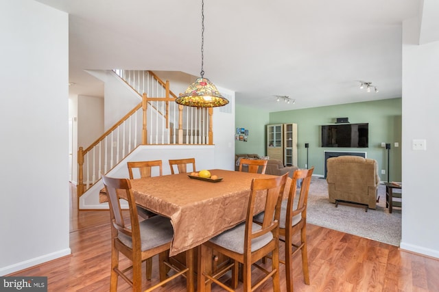 dining room featuring hardwood / wood-style flooring and track lighting