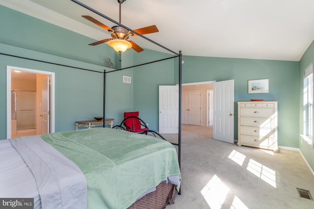 carpeted bedroom with vaulted ceiling, ensuite bathroom, and ceiling fan