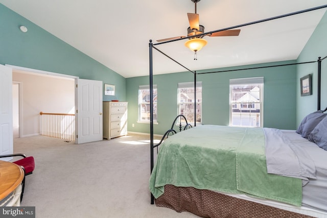 bedroom with lofted ceiling and light colored carpet