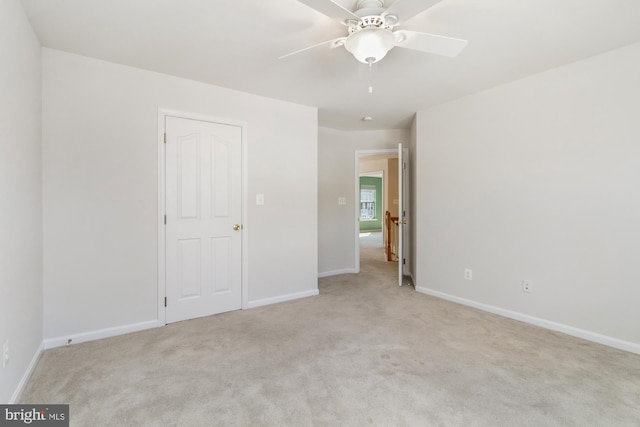 unfurnished bedroom featuring light carpet and ceiling fan