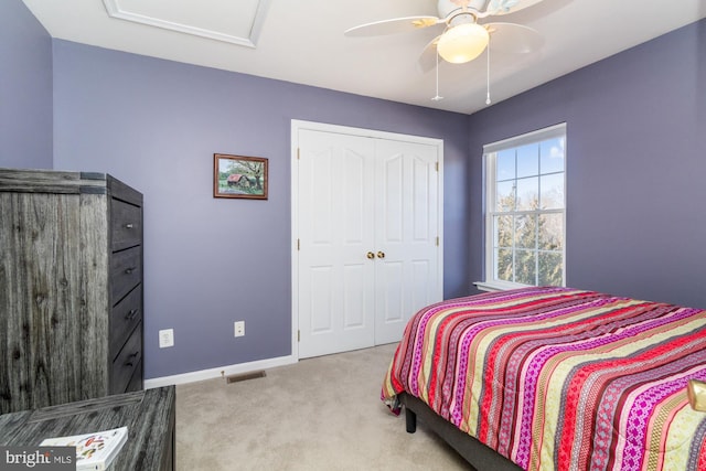 carpeted bedroom with ceiling fan and a closet