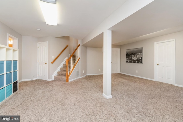 basement featuring light colored carpet