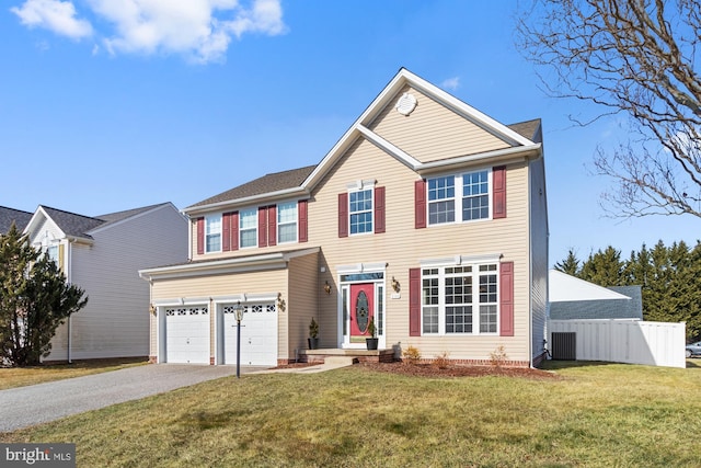 view of front of house featuring a front lawn, central AC unit, and a garage