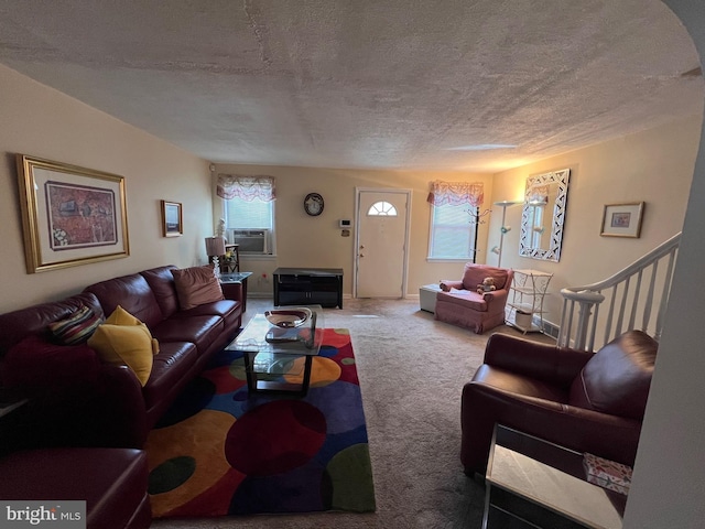 living room with cooling unit, carpet floors, and a textured ceiling