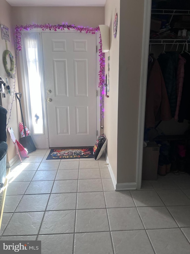 foyer entrance with light tile patterned flooring