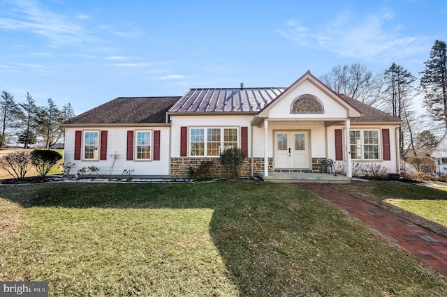 view of front of house with a front yard and french doors