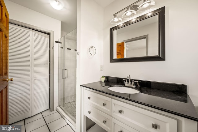 bathroom with vanity, tile patterned flooring, and walk in shower