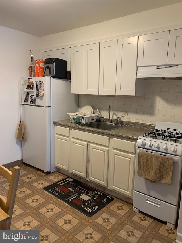 kitchen with sink, white appliances, and white cabinetry