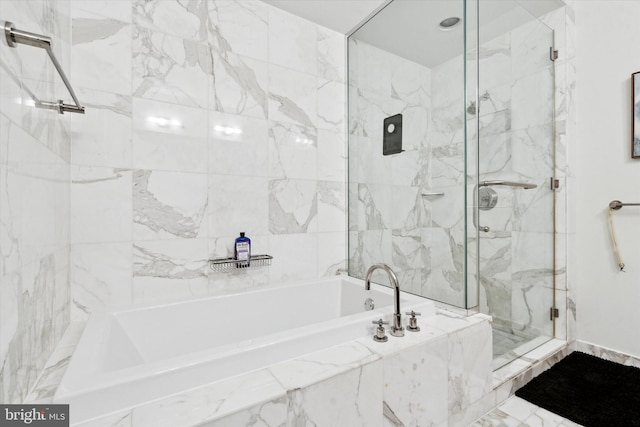 bathroom featuring separate shower and tub