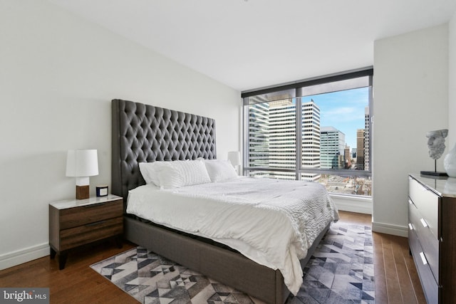 bedroom with dark wood-type flooring