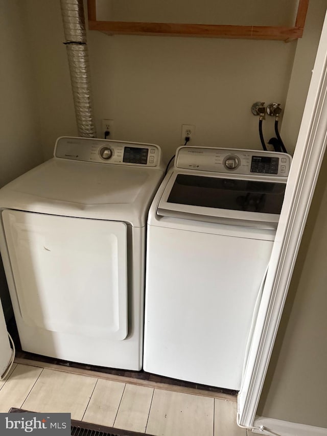 clothes washing area with laundry area and washer and dryer