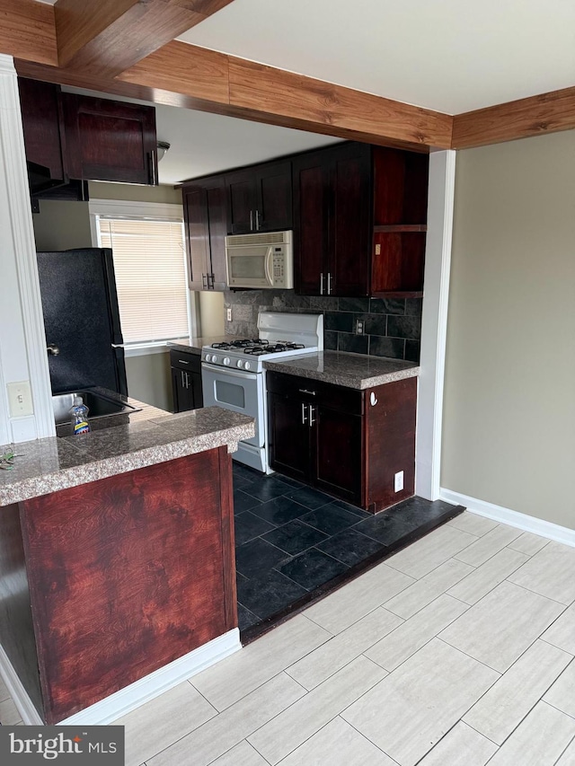 kitchen featuring white appliances, baseboards, decorative backsplash, and open shelves