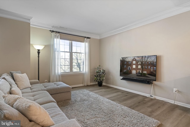 living area featuring crown molding, baseboards, and wood finished floors