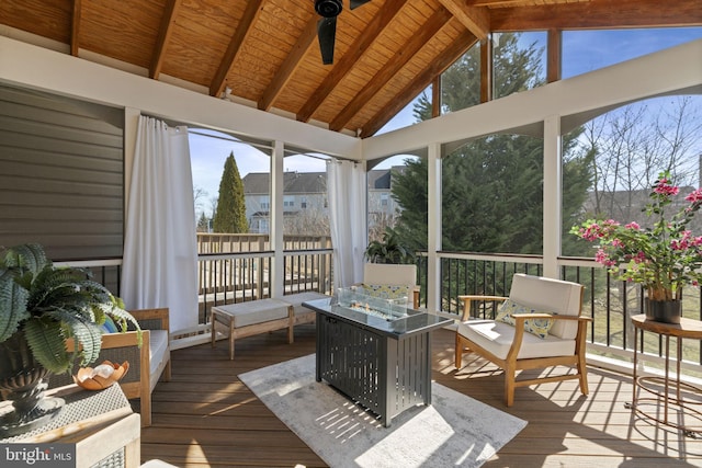 sunroom with vaulted ceiling with beams, wood ceiling, and a wealth of natural light