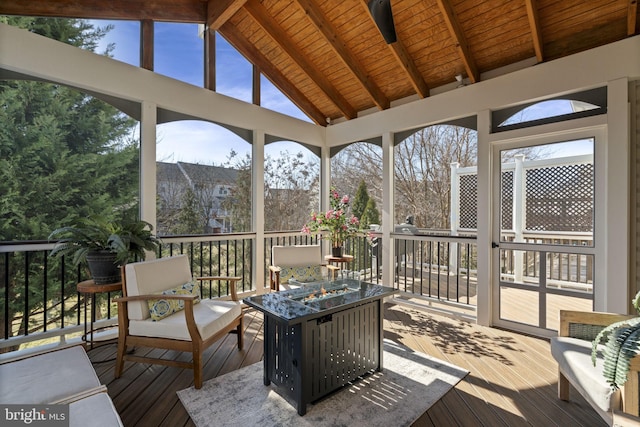 sunroom featuring lofted ceiling with beams and wood ceiling