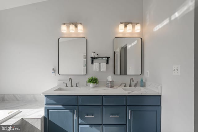 full bath featuring double vanity, a sink, and a bath