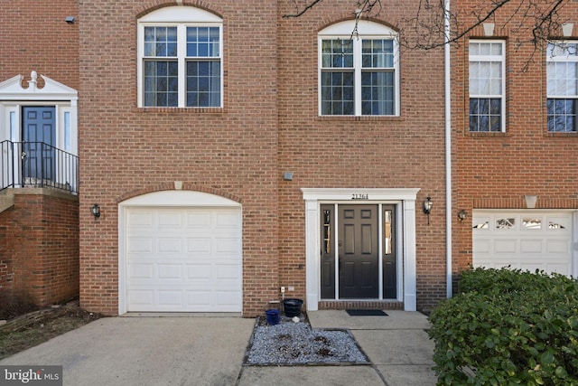 view of front of house with concrete driveway and brick siding