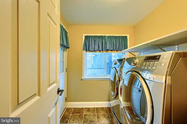 laundry area with washing machine and dryer, laundry area, and baseboards