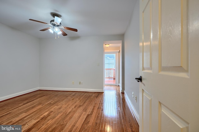 unfurnished room with hardwood / wood-style flooring, baseboards, and a ceiling fan