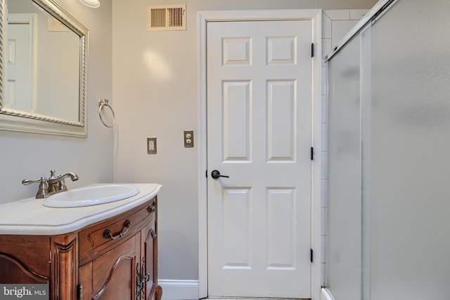 full bathroom featuring visible vents, vanity, and an enclosed shower