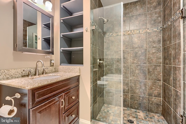 bathroom with a stall shower and vanity