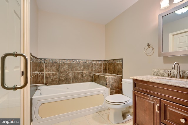 full bath featuring toilet, vanity, tile patterned flooring, and a bath