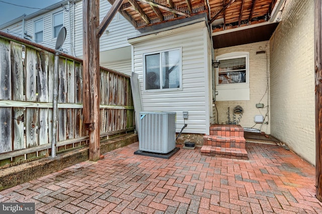 view of patio featuring fence and central air condition unit