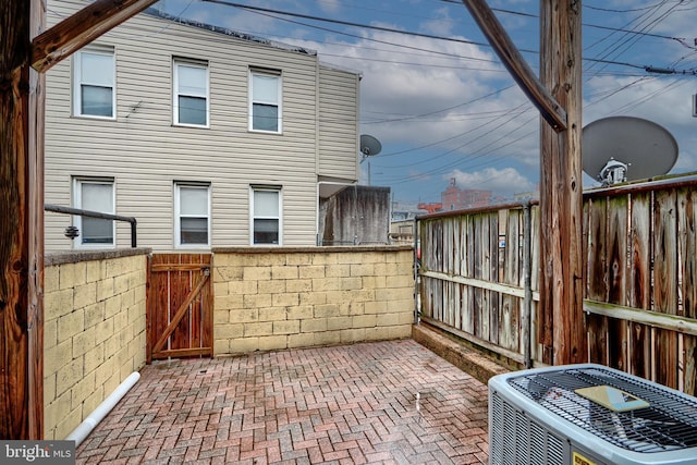 view of patio / terrace with fence, a gate, and central air condition unit