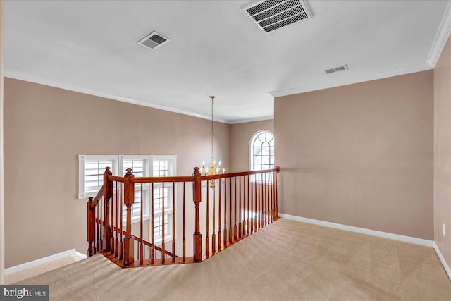 corridor featuring a chandelier, carpet floors, visible vents, and baseboards