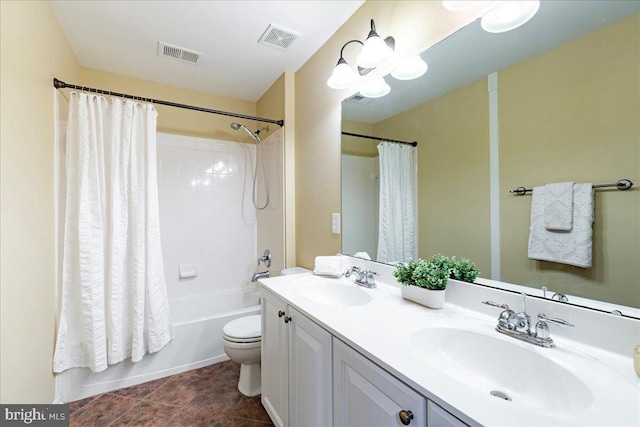 bathroom featuring toilet, visible vents, and a sink