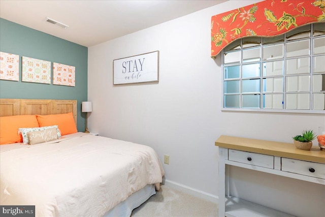 bedroom with carpet, visible vents, and baseboards