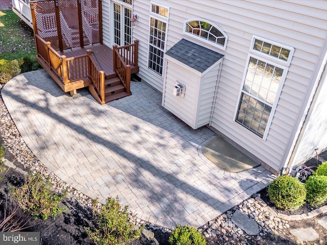 wooden terrace with a patio area