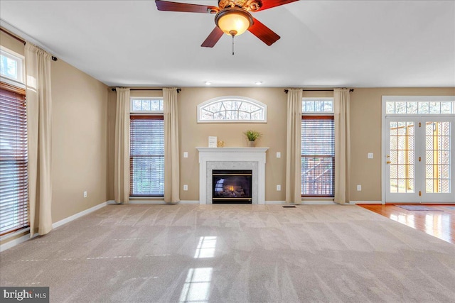 unfurnished living room with carpet floors, french doors, and plenty of natural light