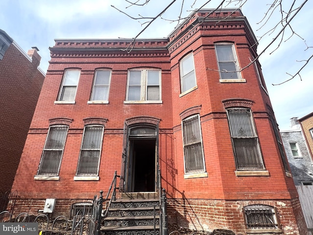 view of front of property with entry steps and brick siding