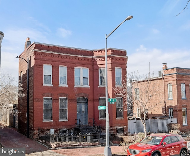 view of building exterior featuring a fenced front yard