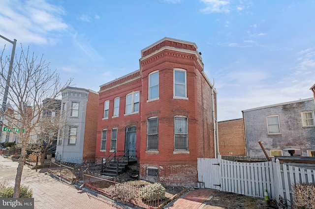 view of building exterior featuring a fenced front yard