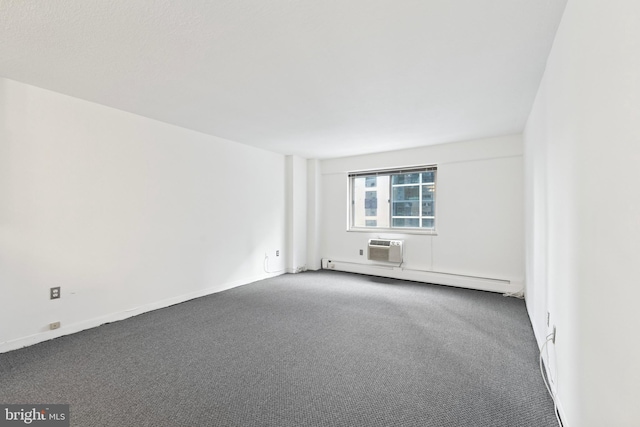 carpeted spare room with a baseboard radiator