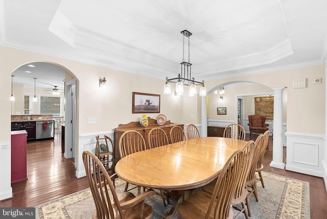 9801 Alydar Ct, Nokesville, VA 20181 - dining room with crown molding, wainscoting, arched walkways, a raised ceiling, and dark wood-style flooring