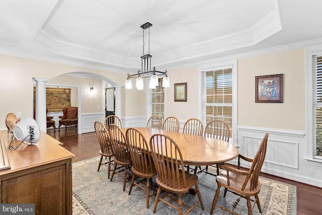 9801 Alydar Ct, Nokesville, VA 20181 - dining room with a wainscoted wall, a tray ceiling, wood finished floors, arched walkways, and decorative columns